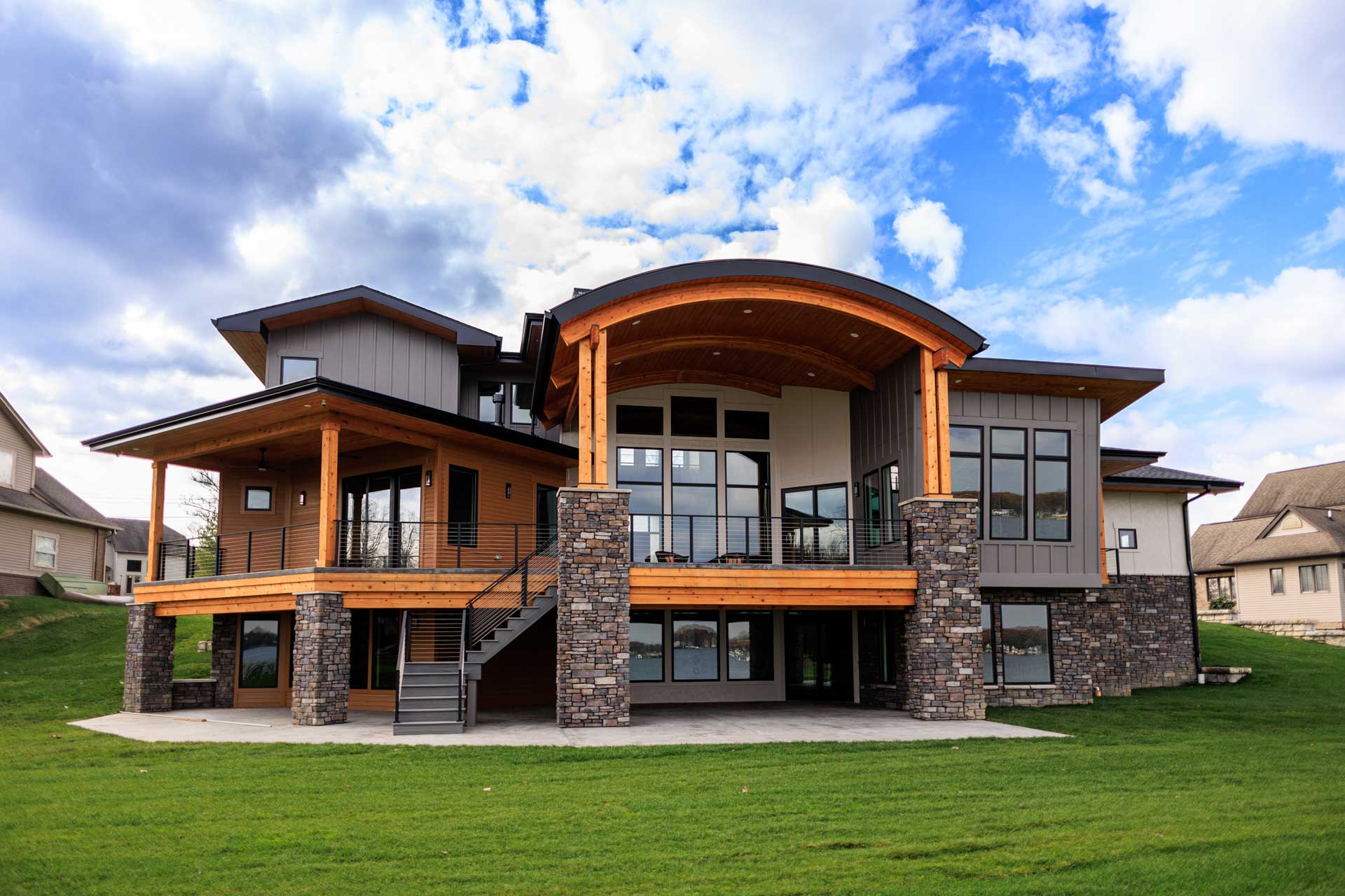 Woodline Building Company Modern Lakefront Lake Nepessing Lapeer, Michigan Rear Elevation with Deck and Curved Roof
